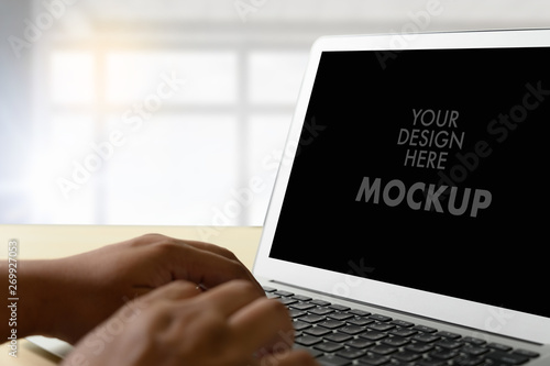 Mockup of business man using laptop screen for your advertising text message