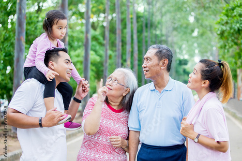 Asian multi generation family chatting in the park