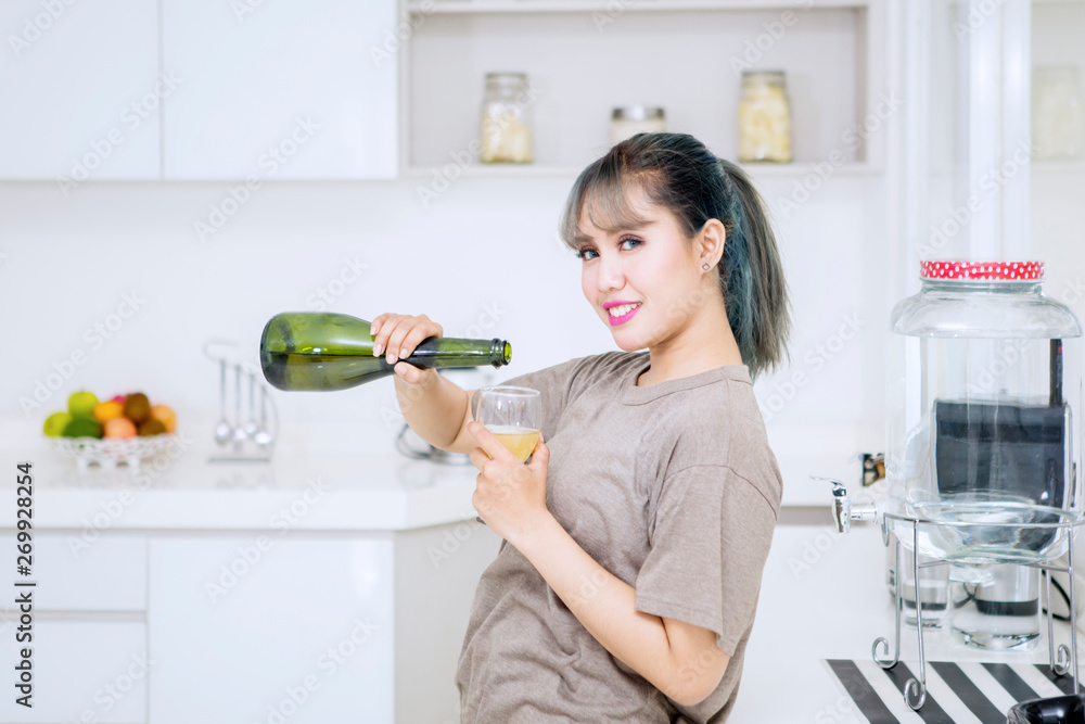 Beautiful woman pouring champagne into a glass Beautiful woman pouring champagne into a glass
