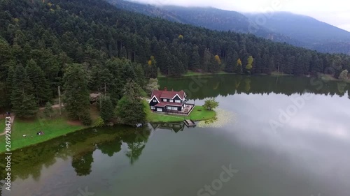 lake and mountain among house drone shooting photo