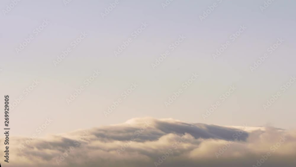 Rolling Clouds Over Mountain in the Distance During Sunset or Sunrise Rolling Clouds Over Mountain in the Distance During Sunset or Sunrise