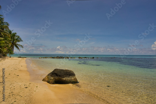 rocks on the beach with crystalline waters and an atmosphere of tranquility photo