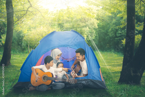 Muslim family enjoys camping holiday in the forest