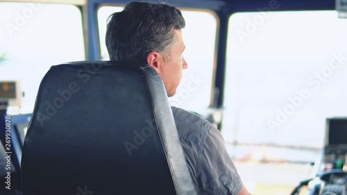 Marine navigational officer during navigational watch on Bridge . Work at sea photo