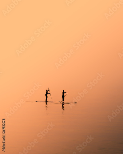 paddle boarding at dawn