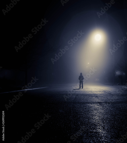 person standing under streetlight