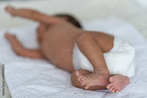 Newborn baby sleeping in bed