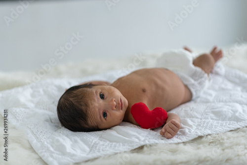 Newborn baby sleeping in bed
