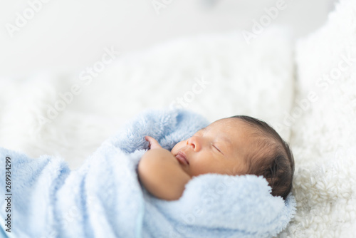 Newborn baby sleeping in bed