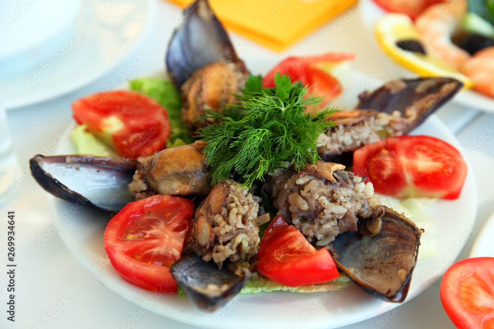 Mussels with tomatoes on the restaurant table Mussels with tomatoes on the restaurant table