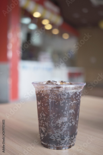 Beverage from cola in glass and a can of sparkling water with ice cube,beverage in summer is sparkling water. photo