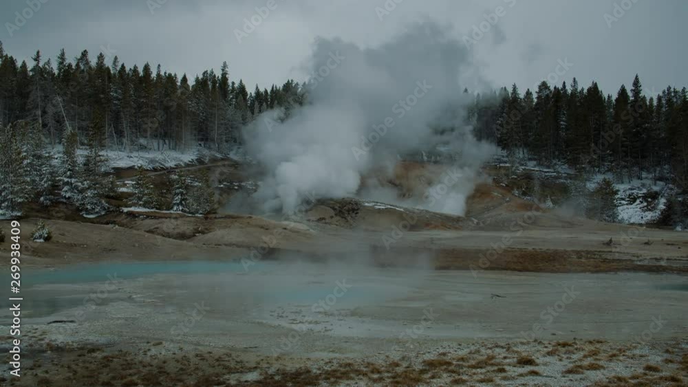 WIDE Steaming geyser pools within Geyser Basin in Yellowstone National Park, Wyoming WIDE Steaming geyser pools within Geyser Basin in Yellowstone National Park, Wyoming