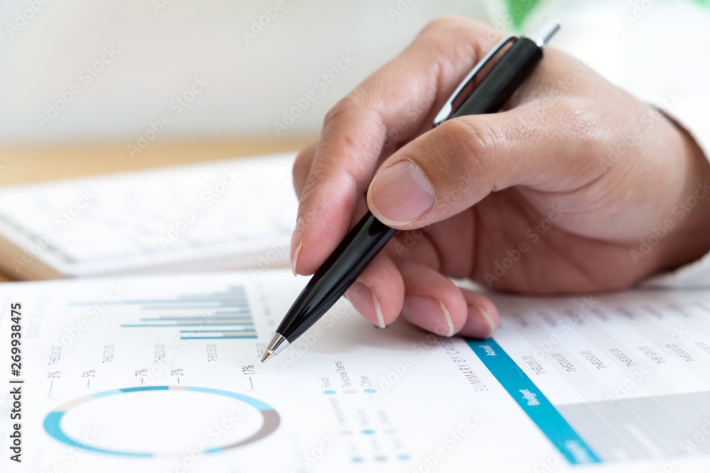 close-up Businessmen financial sitting work checking documents using technology close-up Businessmen financial sitting work checking documents using technology