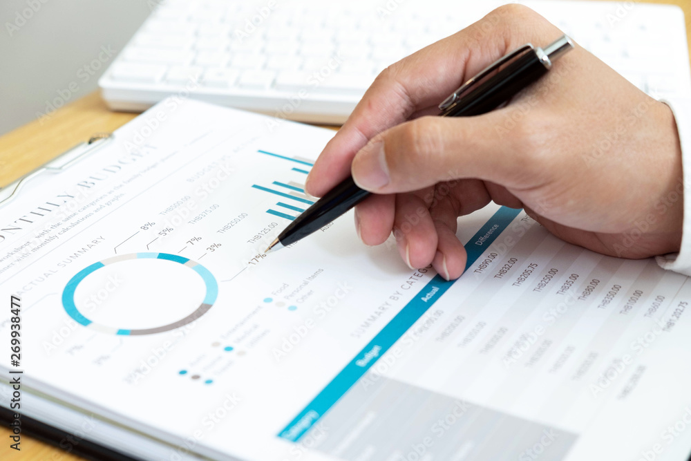 close-up Businessmen financial sitting work checking documents using technology close-up Businessmen financial sitting work checking documents using technology