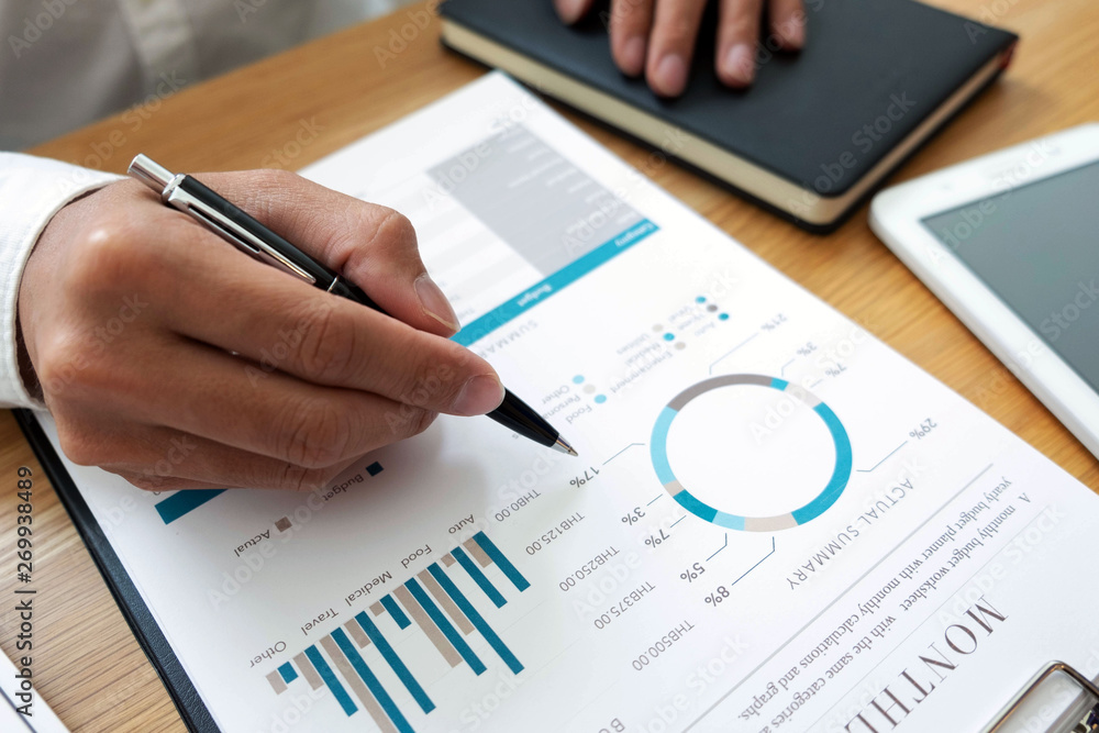 close-up Businessmen financial sitting work checking documents using technology close-up Businessmen financial sitting work checking documents using technology