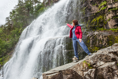 Tourist woman at waterfall Svandalsfossen  Norway