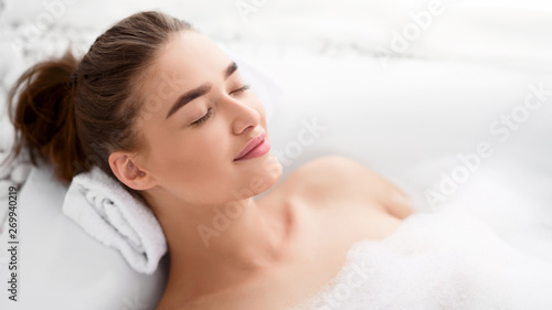 Woman Relaxing In Bath. Girl Bathing With Closed Eyes