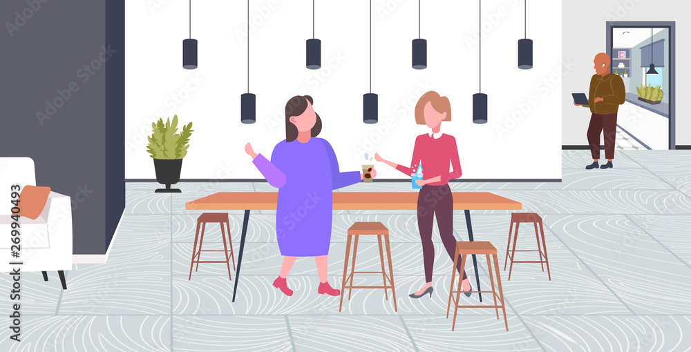 two girls discussing during meeting break for drink at work business time communication concept modern coffee point interior flat full length horizontal