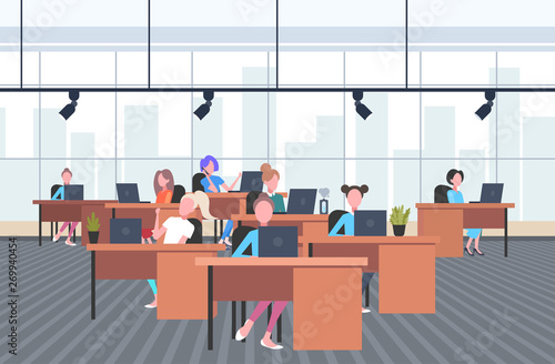 coworkers using laptops in creative office women sitting at workplace desks working process concept co-working open space interior flat horizontal full length