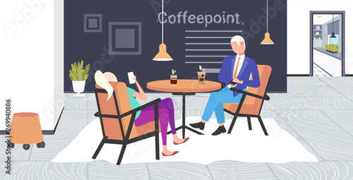 businesspeople using smartphones during corporate break business man woman coworkers sitting cafe table coffee point interior flat full length horizontal