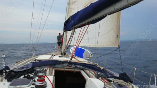 Sailing boat with skipper on the Sardinia sea in Italy, view from the bow. photo