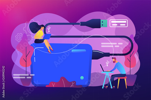 Tiny business people at laptops using portable external hard drive. External hard drive, data storage device, external storage hdd concept. Bright vibrant violet vector isolated illustration