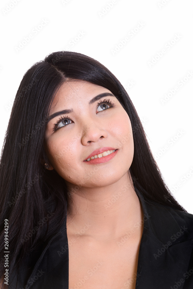 Studio Portrait Of Young Happy Asian Woman Thinking Studio Portrait Of Young Happy Asian Woman Thinking