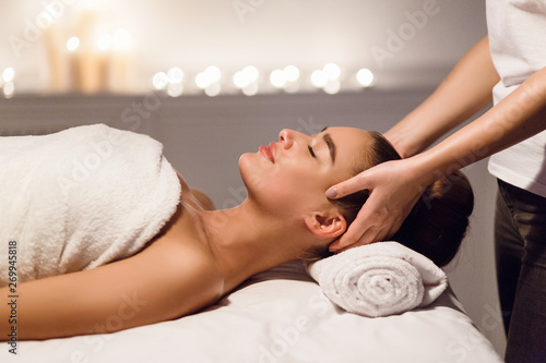 Relaxing Massage. Woman Enjoying Head Massage At Spa