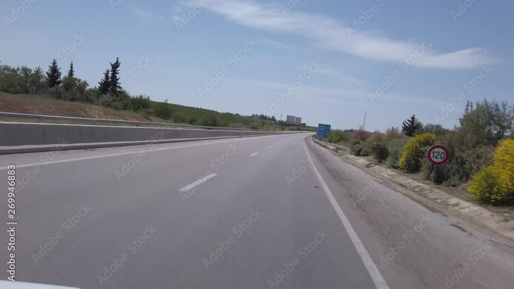 view from a car driving towards Rabat on a highway in Morocco - sign indicating the number of kilometers remaining view from a car driving towards Rabat on a highway in Morocco - sign indicating the number of kilometers remaining