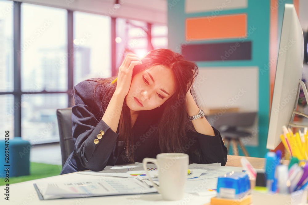 Feeling tired and stressed. Frustrated young woman keeping eyes closed and massaging nose while stay at her working place in office. Feeling tired and stressed. Frustrated young woman keeping eyes closed and massaging nose while stay at her working place in office.