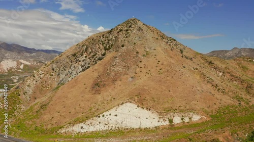 American flag on top of a hill near highway 15 near Phelan, California. Aerial shot. photo