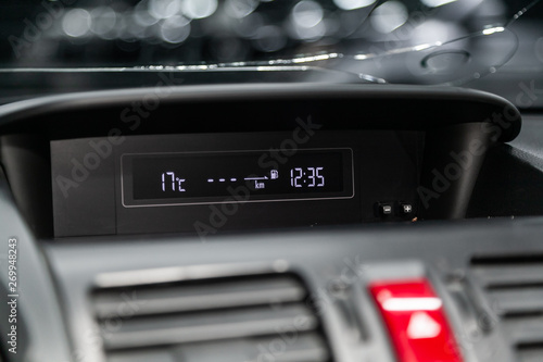Fototapeta Naklejka Na Ścianę i Meble -  Сlose-up of the car  black interior:  dashboard with  temperature, watch, fuel and other informatiom for driver