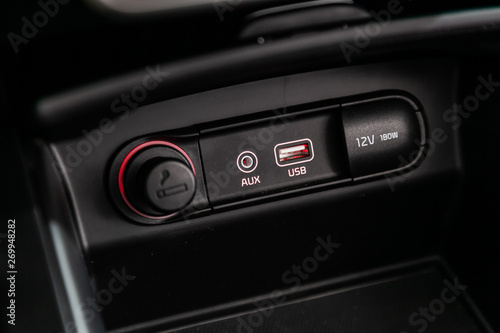 Сlose-up of the car  black interior:  power outlet 12V, USB, AUX and other buttons. © Виталий Сова