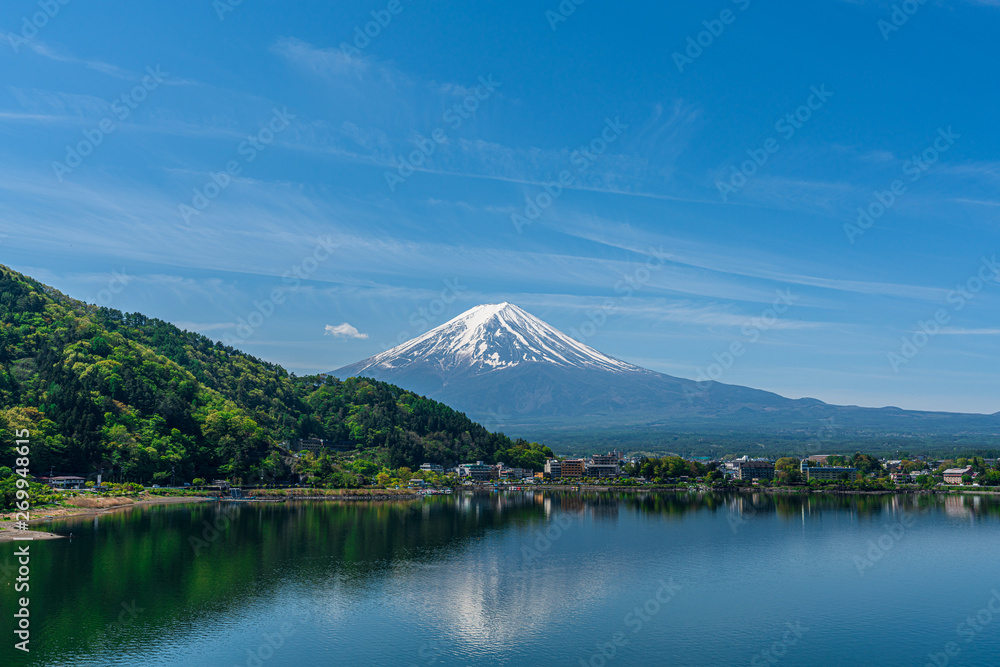 Beautiful Fuji Mountain, Fujisan volcano at Kawaguchiko lake, Japan. Blue sky high peak mountains fog hills mist scenery river lake 