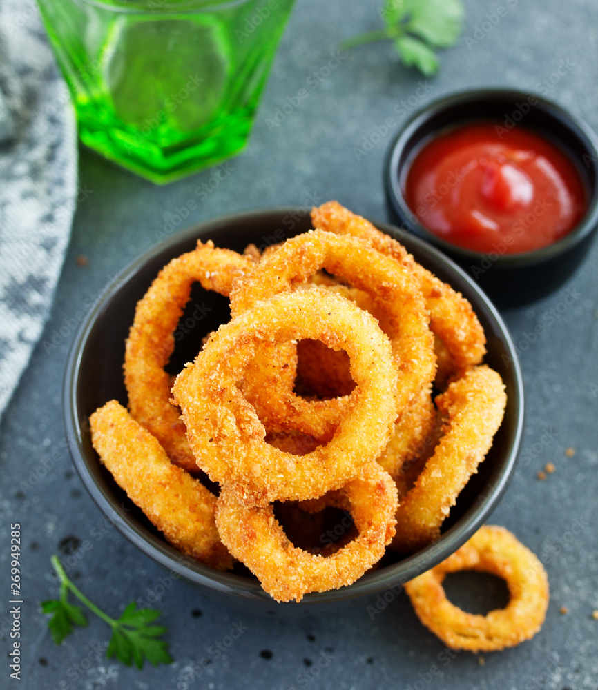 Homemade crunchy fried onion rings with tomato sauce Homemade crunchy fried onion rings with tomato sauce