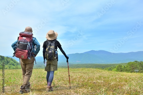高原のトレッキング・草原を歩くカップル