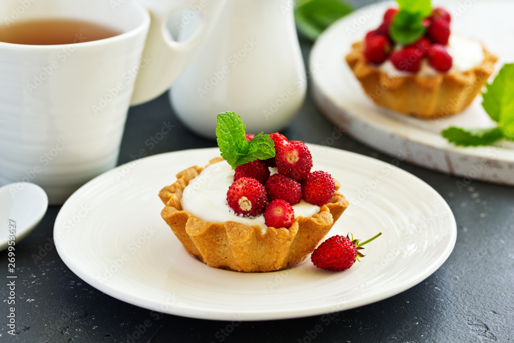 Wild strawberry tartlets with cream filling. delicious summer fruit mini tarts Wild strawberry tartlets with cream filling. delicious summer fruit mini tarts
