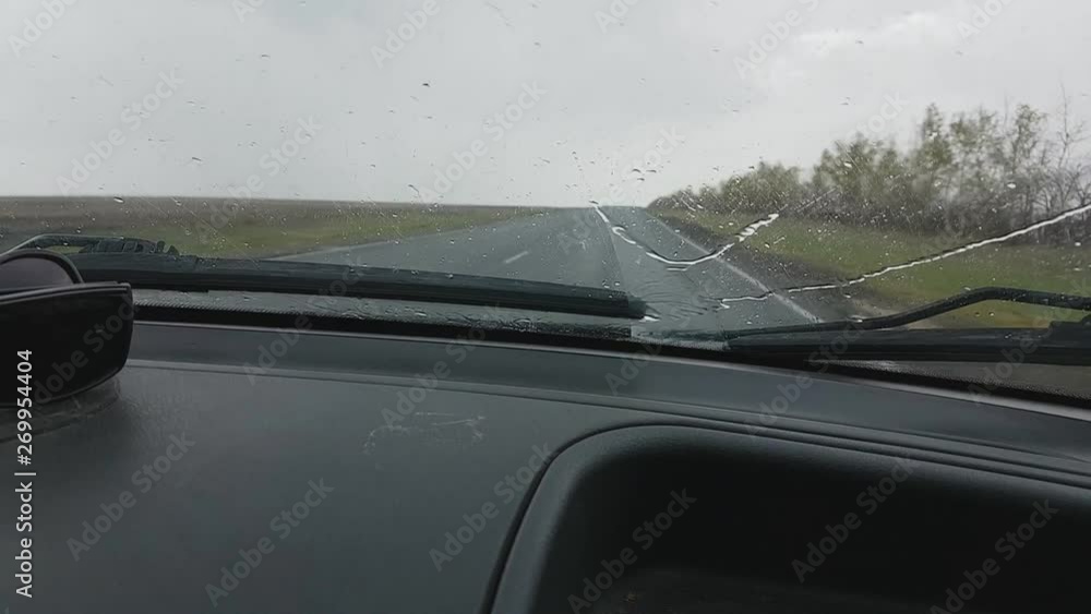 the car gets into a heavy downpour on the highway ,a strong storm with a thunderstorm, global climate change the car gets into a heavy downpour on the highway ,a strong storm with a thunderstorm, global climate change