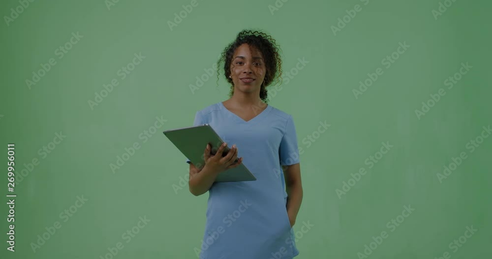 GREEN SCREEN portrait of young attractive African American Black female medic student posing with a tablet portable pc. 4K UHD GREEN SCREEN portrait of young attractive African American Black female medic student posing with a tablet portable pc. 4K UHD