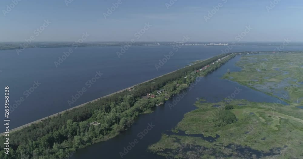 Aerial view. Huge dam. Drone flies over the river, lakes and swamp. 4K Aerial view. Huge dam. Drone flies over the river, lakes and swamp. 4K