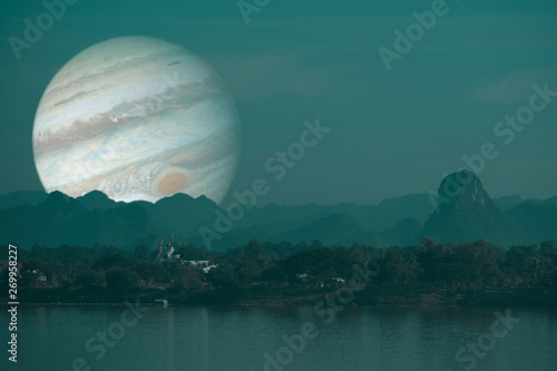 Jupiter planet back silhouette river and mountain inght sky background