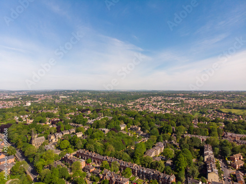 Aerial footage of the Leeds town of Headingley, the footage shows Terrence houses and homes and the town centre in the background with roads and traffic, taken on a beautiful sunny day. © Duncan