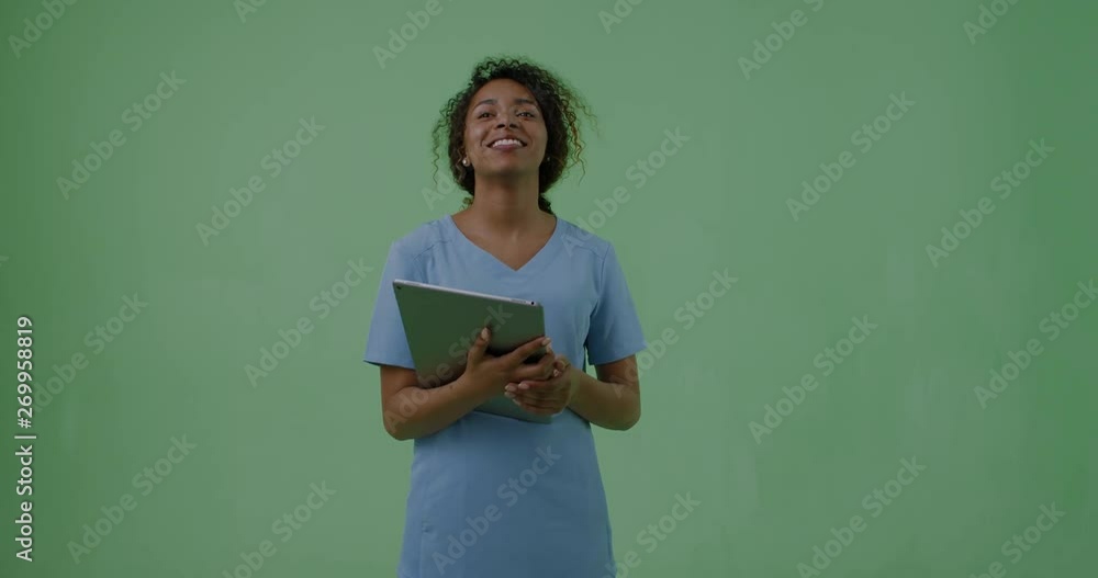 GREEN SCREEN portrait of young attractive African American Black female medic student posing with a tablet portable pc. 4K UHD GREEN SCREEN portrait of young attractive African American Black female medic student posing with a tablet portable pc. 4K UHD