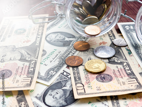 A jar of cash on the table.under jar a lot of dollars, cash, money, concept of accumulation, Finance, business, Economics photo