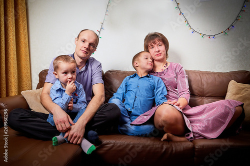 Happy family with two children cheerfully spend house time before Christmas