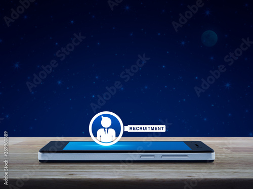 Businessman with magnifying glass icon on modern smart mobile phone screen on wooden table over fantasy night sky and moon  Business recruitment online concept