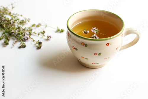 Thyme tea and thyme leaves. Infusion made from thyme leaves. Medicinal herb Thymus vulgaris. The concept of healthy nutrition.