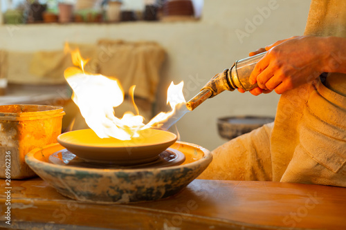 Wallpaper Mural Strong calm man holding special burning tool for baking Torontodigital.ca