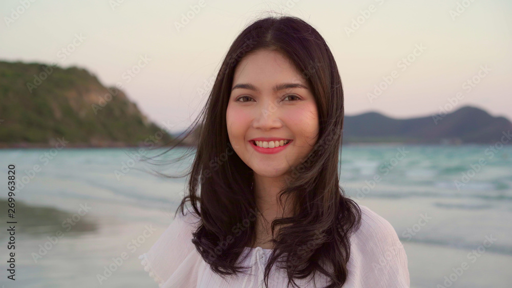 Young Asian woman feeling happy on beach, beautiful female happy relax smiling fun on beach near sea when sunset in evening. Lifestyle women travel on beach concept. Young Asian woman feeling happy on beach, beautiful female happy relax smiling fun on beach near sea when sunset in evening. Lifestyle women travel on beach concept.