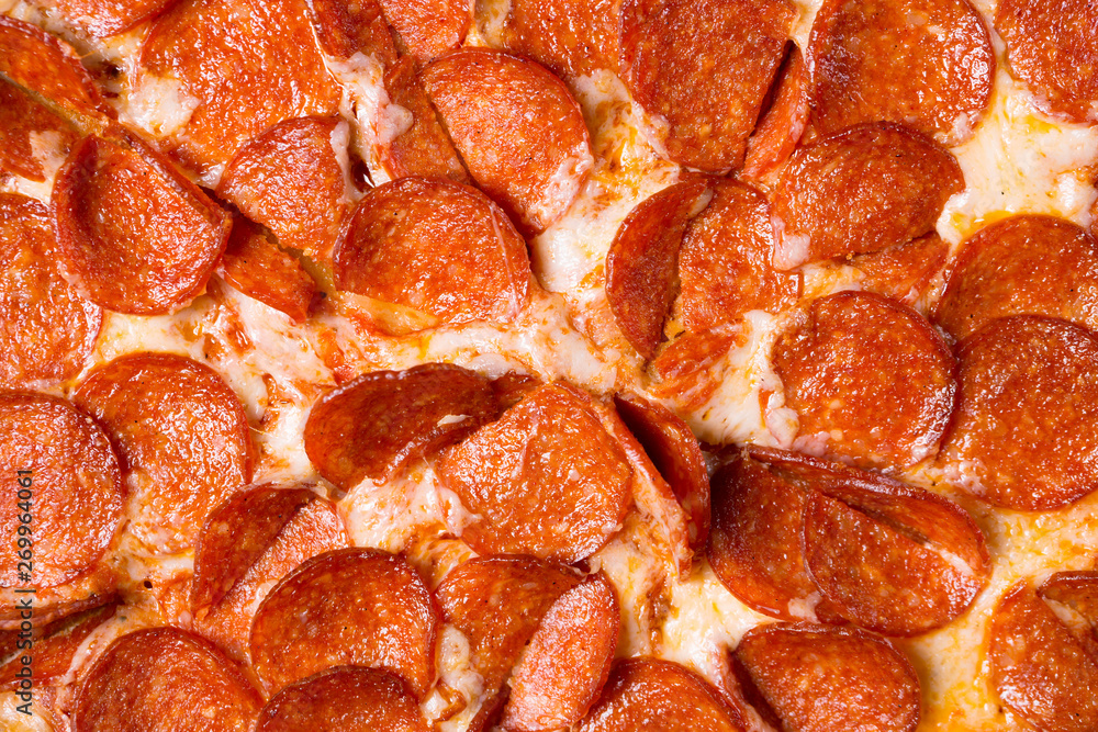 Fresh tasty pepperoni pizza as a background. Pizza close up. Fresh tasty pepperoni pizza as a background. Pizza close up.